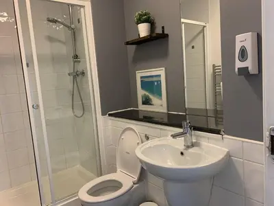 a bathroom with a toilet and a sink and a shower at Modern 2 bedroom flat with free parking in Cambuslang, Glasgow in Glasgow