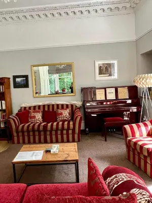 a living room with two couches and a piano at Beautiful Double Room in Idyllic West End Townhouse in Glasgow