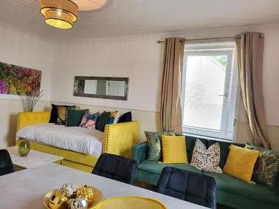 a living room with a couch and a bed at 4 Bedrooms Apartment By Sensational Stay Short Lets & Serviced Accommodation in Edinburgh