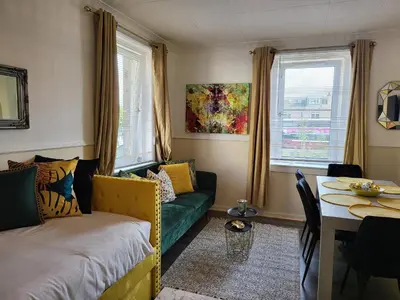 a living room with a couch and a table at 4 Bedrooms Apartment By Sensational Stay Short Lets & Serviced Accommodation in Edinburgh