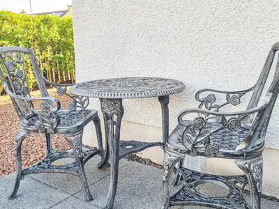 a table and two chairs next to a table and a table and chair at Kirklea in Wishaw