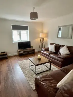 a living room with a couch and a coffee table at Modern 2 bedroom apartment near Glasgow Airport in Paisley
