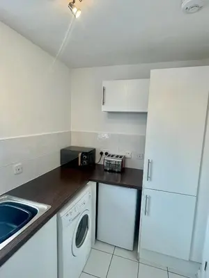 a kitchen with a white refrigerator and a dishwasher at Modern 2 bedroom apartment near Glasgow Airport in Paisley