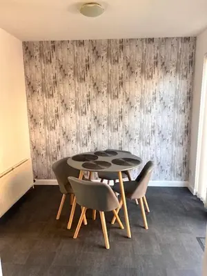 a dining room with a table and some chairs at Kelpies Serviced Apartments- McLaughlan in Falkirk