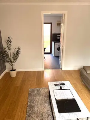 a living room with a couch and a table at Kelpies Serviced Apartments- McLaughlan in Falkirk