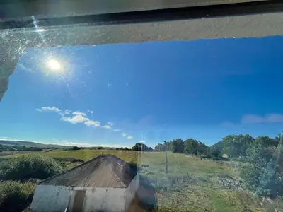 a view of a blue sky from a window at Cozy 2 bedroom cottage with log burner close to Loch Ken in New Galloway