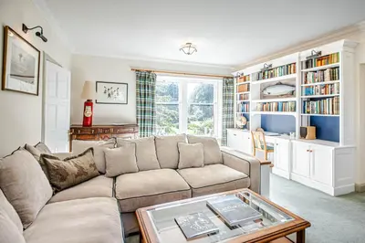 a living room with a couch and a table at The Stables in Castle Douglas