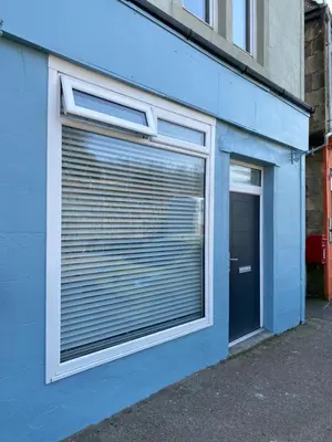 a garage with a large window and a door at Hugmish in Tighnabruaich