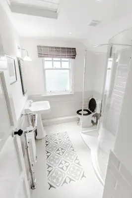 a white bathroom with a shower and a toilet at Diamonds Laggan in Castle Douglas