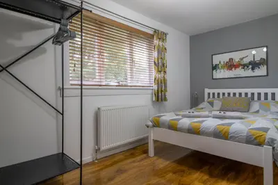 a bedroom with a bed and a window at 1 bed apartment central Hamilton free wifi with great transport links to Glasgow in Hamilton