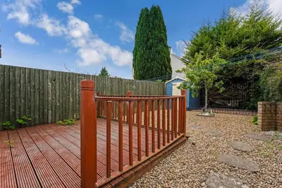 a wooden fence in a backyard with a wooden fence at Centrally Situated 1 Bedroom House in Cumbernauld in Cumbernauld
