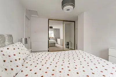 a bedroom with a bed and a large mirror at Centrally Situated 1 Bedroom House in Cumbernauld in Cumbernauld