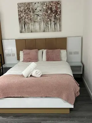 a bedroom with a large bed with two towels on it at Crosskeys Edinburgh in Edinburgh