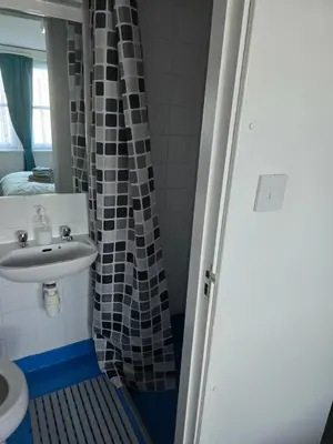 a bathroom with a sink and a shower at The Waterfront in Greenock