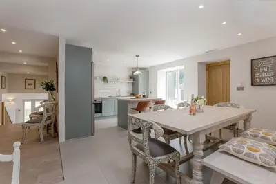 a kitchen and dining room with a table and chairs at Rachel's Farm luxury escapes with Hots Tubs in Buchlyvie