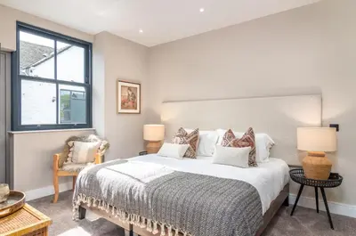 a bedroom with a large bed and a window at Rachel's Farm luxury escapes with Hots Tubs in Buchlyvie