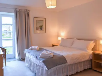 a bedroom with a bed with towels on it at Tigh Nam Muc in Loanhead