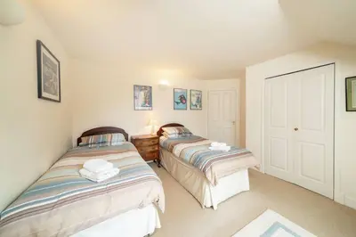two beds in a small room withermottermottermottermott at Earnside Cottage in Comrie