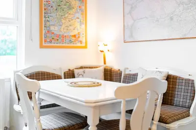 a white table and chairs in a dining room at Earnside Cottage in Comrie