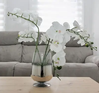 a vase filled with white flowers on a table at Katie's house in Cumbernauld