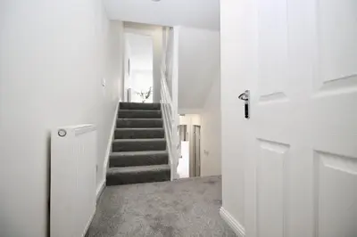 a hallway with a stairway with a stair case at Katie's house in Cumbernauld