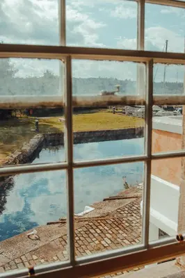 a view through a window of a body of water at Custom House Hotel in Bowling