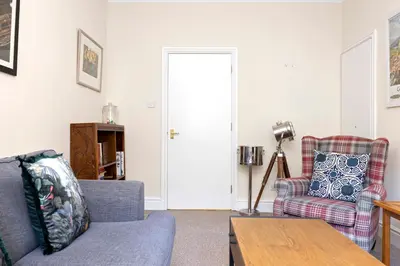 a living room with two chairs and a table at JOIVY Modern Flat on Rose Street in Edinburgh