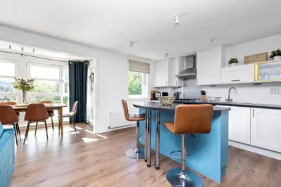 a kitchen and dining room with a table and chairs at JOIVY Modern 2 bed flat near Murrayfield Stadium in Edinburgh