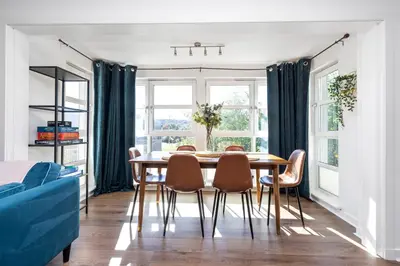 a dining room with a table and chairs at JOIVY Modern 2 bed flat near Murrayfield Stadium in Edinburgh