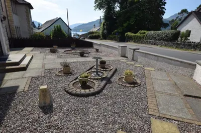 a garden with a fire pit in the middle of a street at Ridgeview Villa - Partial loch view in Lochgoilhead