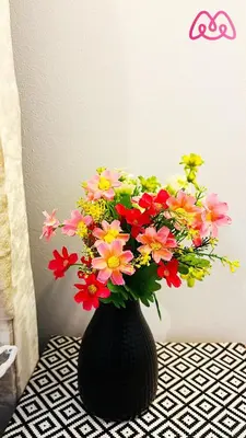 a black vase filled with colorful flowers on a table at 2 Bedrooms Entire Apartment Self Check in in Fife