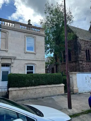 a white car parked in front of a brick house at Number 79, Cosy Central Helensburgh 1 Bedroom, ground floor pet friendly, garden in Helensburgh