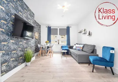 a living room with a couch and a table at Sanderson Apartment by Klass Living Uddingston in Uddingston