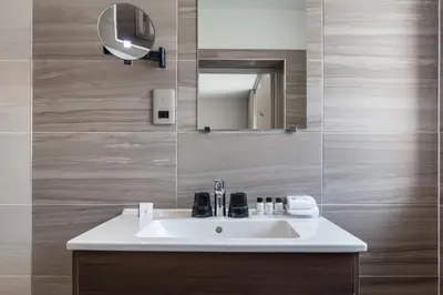 a bathroom with a sink and a mirror at Colessio in Stirling