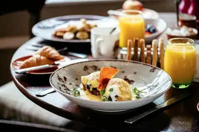 a table with a bowl of food and orange juice at Colessio in Stirling