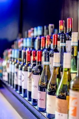 a row of wine bottles sitting on a shelf at Colessio in Stirling