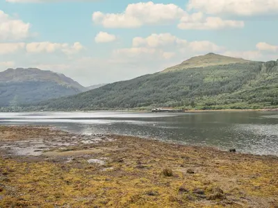 a body of water with mountains in the background at Beechwood in Arrochar