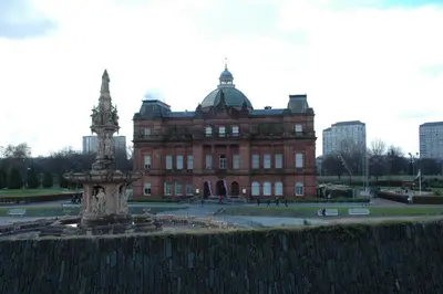 a large brick building with a fountain in front of it at The Nelson - Spacious City Property and Free Parking in Glasgow