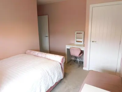 a bedroom with a bed and a desk and a chair at Beautiful 3 bedroom home with large garden 35 mins to Glasgow & Edinburgh in Whitburn