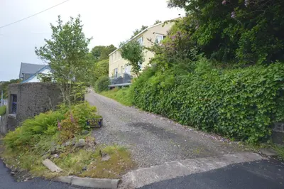 an empty road in front of a house at Ardura Apartment No 2 in Oban