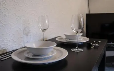 a table with two glasses and a bowl and a bowl at George Street Apartment in Oban