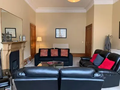 a living room with two leather couches and a fireplace at JOIVY Adorable flat near West End in Edinburgh