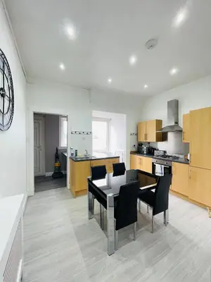a kitchen and dining room with a table and chairs at Spacious 3 Bedroom Entire Apartment Self Check in in Fife