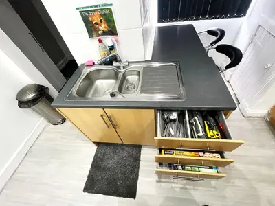 a kitchen with a sink and a counter at Spacious 3 Bedroom Entire Apartment Self Check in in Fife
