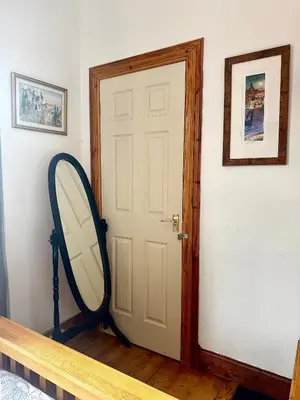 a mirror sitting next to a door in a room at 4B Millhill Street in Dunfermline