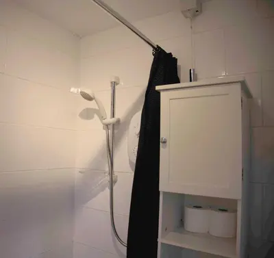 a shower in a bathroom with a black shower curtain at The Kelvin - Peaceful West End River View Property in Glasgow