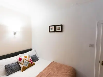 a bedroom with a bed with two pictures on the wall at West End Studio Kelvingrove Park Museum - Pass the Keys in Glasgow