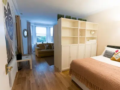 a bedroom with a bed and a room with a couch at West End Studio Kelvingrove Park Museum - Pass the Keys in Glasgow