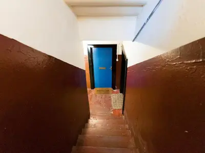 a stairway with a blue door in a building at West End Studio Kelvingrove Park Museum - Pass the Keys in Glasgow