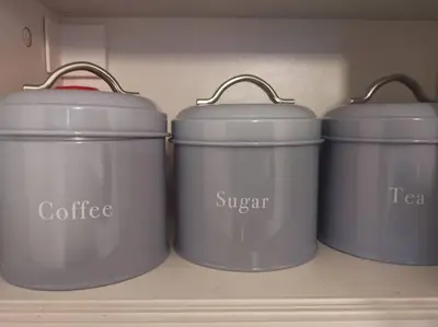 four pots sitting on a shelf in a closet at Castleview is a lovely flat in a listed building in Rothesay